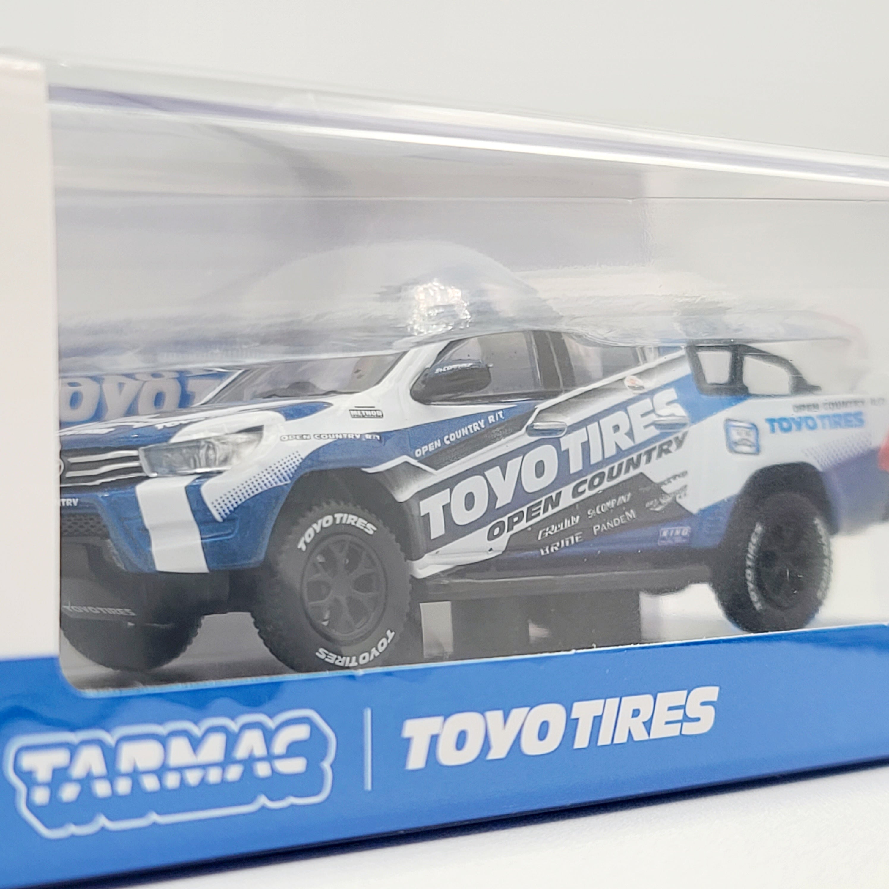Tarmac Works Toyota Hilux Pickup Truck - 1:64, Toyo Tires (2025 Hobby64)